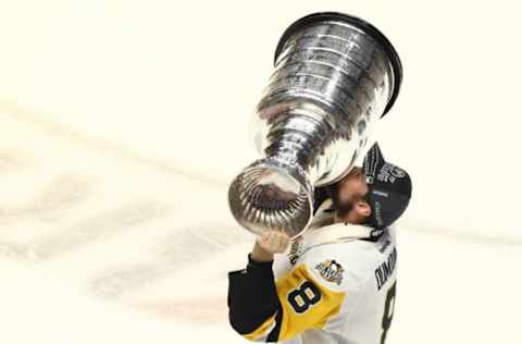 Jun 11, 2017; Nashville, TN, USA; Pittsburgh Penguins defenseman Brian Dumoulin (8) skates with the Stanley Cup after defeating the Nashville Predators in game six of the 2017 Stanley Cup Final at Bridgestone Arena. Mandatory Credit: Aaron Doster-USA TODAY Sports