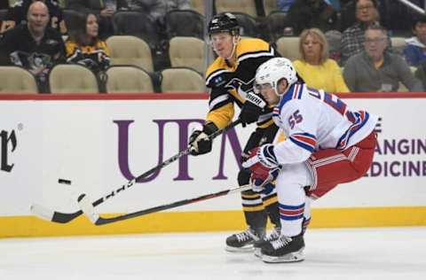 PITTSBURGH, PA – DECEMBER 20: Kasperi Kapanen #42 of the Pittsburgh Penguins attempts a shot as Ryan Lindgren #55 of the New York Rangers defends in the first period during the game at PPG PAINTS Arena on December 20, 2022 in Pittsburgh, Pennsylvania. (Photo by Justin Berl/Getty Images)