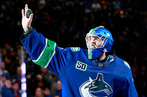 VANCOUVER, BC – DECEMBER 12: Jacob Markstrom #25 of the Vancouver Canucks holds up a puck while being named first star after their NHL game against the Carolina Hurricanes at Rogers Arena December 12, 2019 in Vancouver, British Columbia, Canada. Vancouver won 1-0. (Photo by Jeff Vinnick/NHLI via Getty Images)