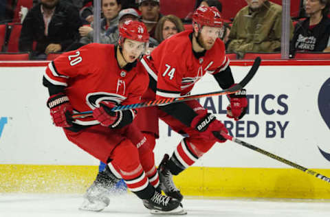 RALEIGH, NC – OCTOBER 29: Carolina Hurricanes Center Sebastian Aho (20) and Carolina Hurricanes Defenceman Jaccob Slavin (74) skate the puck up ice during a game between the Calgary Flames and the Carolina Hurricanes at the PNC Arena in Raleigh, NC on October 29, 2019. (Photo by Greg Thompson/Icon Sportswire via Getty Images)