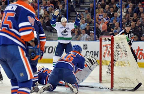 Oct 17, 2014; Edmonton, Alberta, CAN; Vancouver Canucks right wing Radim Vrbata (17) celebrates after scoring a goal against Edmonton Oilers goalie Ben Scrivens (30) during the second period of the game at Rexall Place. Mandatory Credit: Steve Alkok-USA TODAY Sports