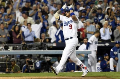 Oct 18, 2016; Los Angeles, CA, USA; Los Angeles Dodgers catcher Yasmani Grandal (9) reacts after hitting two run home run during the fourth inning against the Chicago Cubs in game three of the 2016 NLCS playoff baseball series at Dodger Stadium. Mandatory Credit: Richard Mackson-USA TODAY Sports