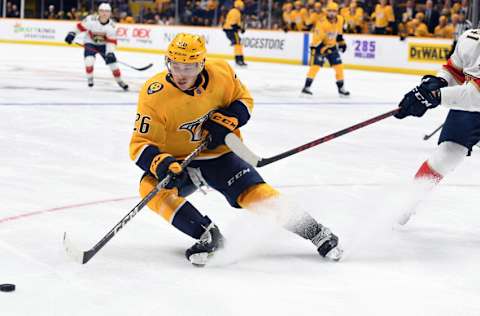 Sep 26, 2022; Nashville, Tennessee, USA; Nashville Predators center Philip Tomasino (26) skates with the puck during the third period against the Florida Panthers at Bridgestone Arena. Mandatory Credit: Christopher Hanewinckel-USA TODAY Sports