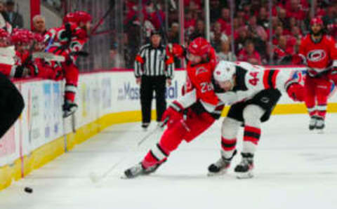 May 11, 2023; Raleigh, North Carolina, USA; Carolina Hurricanes left wing Mackenzie MacEachern (28) and New Jersey Devils left wing Miles Wood (44) battle over the puck during the third period in game five of the second round of the 2023 Stanley Cup Playoffs at PNC Arena. Mandatory Credit: James Guillory-USA TODAY Sports