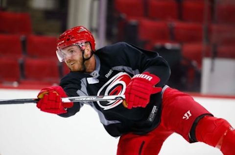 Sept 18, 2015; Raleigh, NC, USA; Carolina Hurricanes defensemen James Wisniewski (21) watches his shot at PNC Arena. Mandatory Credit: James Guillory-USA TODAY Sports