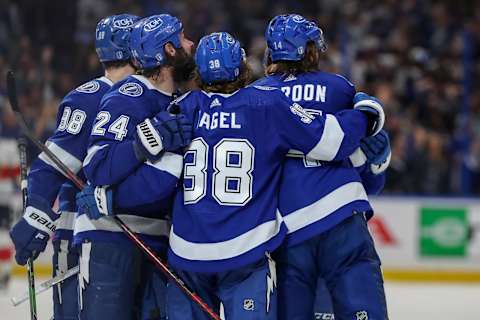 TAMPA, FL – MAY 23: Pat Maroon #14 of the Tampa Bay Lightning, right, looks up at the video board of a replay of his goal against the Florida Panthers as he celebrates with Mikhail Sergachev #98, Zach Bogosian #24, and Brandon Hagel during the third period in Game Four of the Second Round of the 2022 Stanley Cup Playoffs at Amalie Arena on May 23, 2022 in Tampa, Florida. (Photo by Mike Carlson/Getty Images)