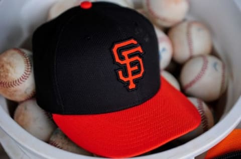 Mar 11, 2015; Scottsdale, AZ, USA; A San Francisco Giants giants hat sits in a bucket of baseballs during the game against the Milwaukee Brewers at Scottsdale Stadium. Mandatory Credit: Matt Kartozian-USA TODAY Sports