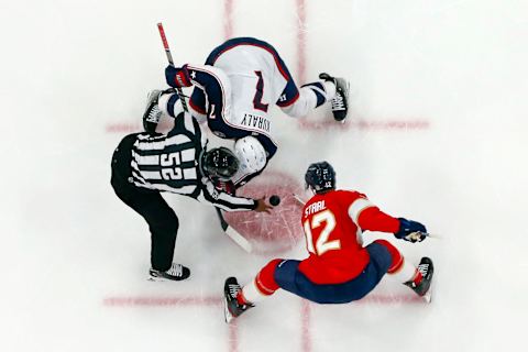 SUNRISE, FL – DECEMBER 13: Linesman Shandor Alphonso #52 drops the puck between Eric Staal #12 of the Florida Panthers and Sean Kuraly #7 of the Columbus Blue Jackets at the FLA Live Arena on December 13, 2022 in Sunrise, Florida. (Photo by Joel Auerbach/Getty Images)