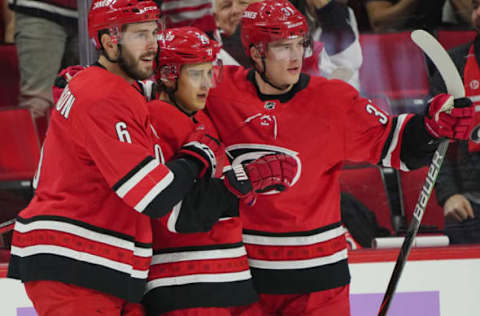 RALEIGH, NC – NOVEMBER 21: Sebastian Aho #20 of the Carolina Hurricanes scores a goal and celebrates with teammates Joel Edmundson #6 and Andrei Svechnikov #37 during an NHL game against the Philadelphia Flyers on November 21, 2019 at PNC Arena in Raleigh, North Carolina. (Photo by Gregg Forwerck/NHLI via Getty Images)