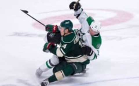 Oct 29, 2016; Saint Paul, MN, USA; Minnesota Wild forward Joel Eriksson Ek (14) checks Dallas Stars forward Antoine Roussel (21) in the third period at Xcel Energy Center. The Minnesota Wild beat the Dallas Stars 4-0. Mandatory Credit: Brad Rempel-USA TODAY Sports