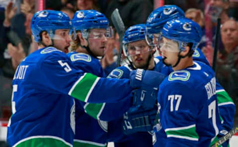 VANCOUVER, BC – FEBRUARY 25: Nikolay Goldobin #77 of the Vancouver Canucks is congratulated by teammates Elias Pettersson #40, Derrick Pouliot #5, and Brock Boeser #6 after scoring during their NHL game against the Anaheim Ducks at Rogers Arena February 25, 2019 in Vancouver, British Columbia, Canada. (Photo by Jeff Vinnick/NHLI via Getty Images)