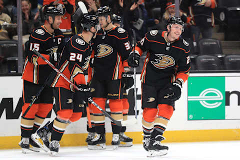 ANAHEIM, CALIFORNIA – MARCH 10: Carter Rowney #24, Ryan Getzlaf #15, and Jacob Larsson #32 congratulate Nicolas Deslauriers #20 of the Anaheim Ducks (Photo by Sean M. Haffey/Getty Images)