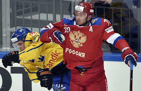 Russia’s Ilya Kovalchuck (R) fights for the puck with Sweden’s Pathrik Westrholm during the Channel One Cup of the Euro Hockey Tour ice hockey match between Russia and Sweden in Moscow on December 15, 2016. / AFP / Alexander NEMENOV (Photo credit should read ALEXANDER NEMENOV/AFP/Getty Images)