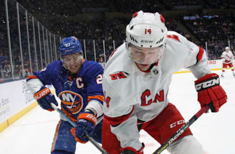 UNIONDALE, NEW YORK – MARCH 07: Justin Williams #14 of the Carolina Hurricanes moves the puck ahead of Anders Lee #27 of the New York Islanders during the second period at NYCB Live’s Nassau Coliseum on March 07, 2020 in Uniondale, New York. (Photo by Bruce Bennett/Getty Images)