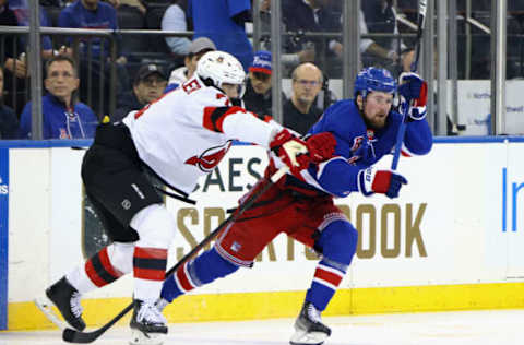 NEW YORK, NEW YORK – APRIL 24: Jonas Siegenthaler #71 of the New Jersey Devils pushes Alexis Lafreniere #13 of the New York Rangers during the second period in Game Four of the First Round of the 2023 Stanley Cup Playoffs at Madison Square Garden on April 24, 2023, in New York, New York. (Photo by Bruce Bennett/Getty Images)