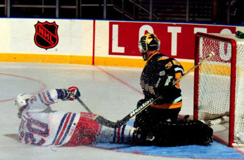 2000 Season: Luc Robitaille slides into Ken Wregett and pucks slides left of the net. (Photo by John Giamundo/Getty Images)