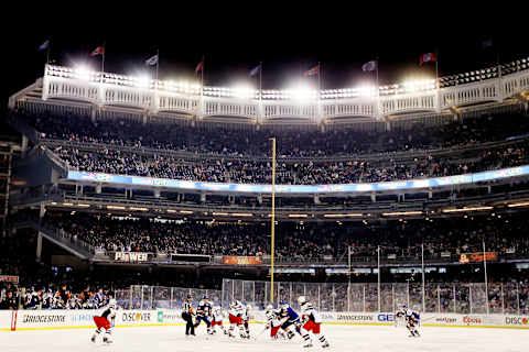 The New York Rangers face off during the 2014 Coors Light NHL Stadium Series at Yankee Stadium on January 29, 2014(Photo by Elsa/Getty Images)