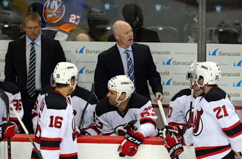 Sep 23, 2015; Brooklyn, NY, USA; New Jersey Devils head coach John Hynes (center) coaches against the New York Islanders during the third period at Barclays Center. Mandatory Credit: Brad Penner-USA TODAY Sports