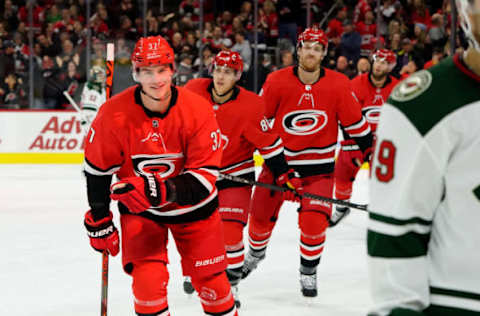 RALEIGH, NC – DECEMBER 07: Andrei Svechnikov #37 of the Carolina Hurricanes skates to the bench with teammates to celebrate a goal during an NHL game against the Minnesota Wild on December 7, 2019 at PNC Arena in Raleigh, North Carolina. (Photo by Gregg Forwerck/NHLI via Getty Images)