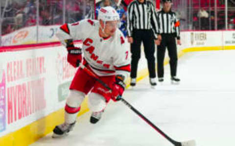 Sep 26, 2023; Raleigh, North Carolina, USA; Carolina Hurricanes defenseman Dmitry Orlov (7) skates with the puck at during the first period at PNC Arena. Mandatory Credit: James Guillory-USA TODAY Sports