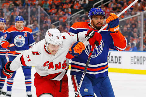 Dec 6, 2023; Edmonton, Alberta, CAN; Edmonton Oilers forward Evander Kane (91) and Carolina Hurricanes forward Jesper Fast (71) chase a loose puck during the second period at Rogers Place. Mandatory Credit: Perry Nelson-USA TODAY Sports