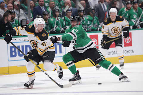 DALLAS, TX – OCTOBER 3: Matt Grzelcyk #48 of the Boston Bruins tries to keep the puck away against Alexander Radulov #47 of the Dallas Stars at the American Airlines Center on October 3, 2019 in Dallas, Texas. (Photo by Glenn James/NHLI via Getty Images)