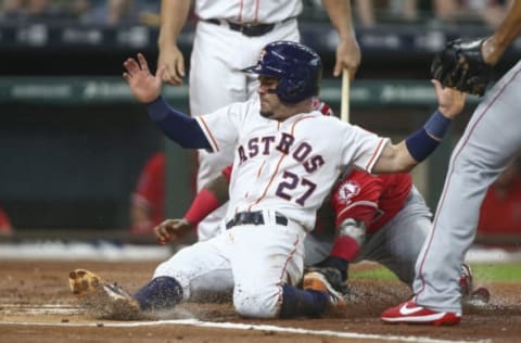 Apr 19, 2017; Houston, TX, USA; Houston Astros second baseman Jose Altuve (27) is tagged out by Los Angeles Angels catcher Martin Maldonado (12) on a play at the plate during the first inning at Minute Maid Park. Mandatory Credit: Troy Taormina-USA TODAY Sports