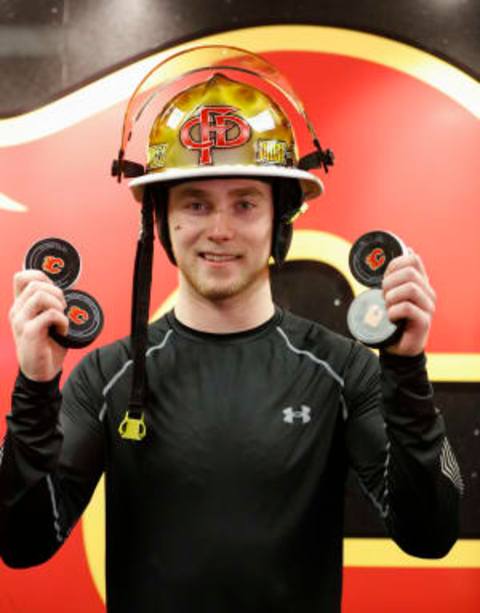 CALGARY, AB – JANUARY 13: am Bennett #93 of the Calgary Flames holds up all four of his goal pucks against the Florida Panthers. (Photo by Gerry Thomas/NHLI via Getty Images)