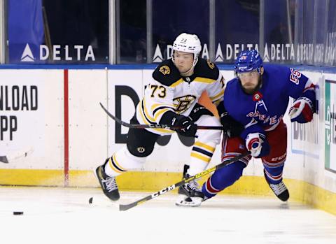 Feb 10, 2021; New York, New York, USA; Charlie McAvoy #73 of the Boston Bruins checks Ryan Lindgren #55 of the New York Rangers against the boards during the second period at Madison Square Garden. Mandatory Credit: Bruce Bennett/Pool Photo-USA TODAY Sports