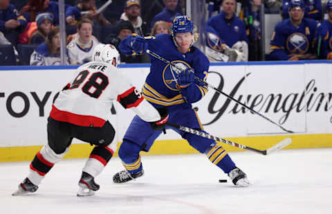 Feb 17, 2022; Buffalo, New York, USA; Buffalo Sabres defenseman Rasmus Dahlin (26) plays the puck between his legs as Ottawa Senators defenseman Victor Mete (98) defends during the second period at KeyBank Center. Mandatory Credit: Timothy T. Ludwig-USA TODAY Sports