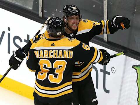 BOSTON – NOVEMBER 21: Boston Bruins center Brad Marchand (63) and Boston Bruins right wing David Pastrnak (88) celebrate what proved to be the game-winning goal by Pastrnak during the third period. The Boston Bruins host the Buffalo Sabres in a regular season NHL hockey game at TD Garden in Boston on Nov. 21, 2019. (Photo by Barry Chin/The Boston Globe via Getty Images)