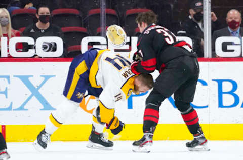 Apr 15, 2021; Raleigh, North Carolina, USA; Carolina Hurricanes right wing Andrei Svechnikov (37) fights Nashville Predators defenseman Mattias Ekholm (14) during the second period at PNC Arena. Mandatory Credit: James Guillory-USA TODAY Sports