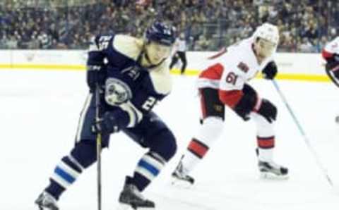 Feb 13, 2016; Columbus, OH, USA; Columbus Blue Jackets center William Karlsson (25) takes a backhand shot under pressure from Ottawa Senators right wing Mark Stone (61) at Nationwide Arena. The Blue Jackets won the game 4-2. Mandatory Credit: Greg Bartram-USA TODAY Sports