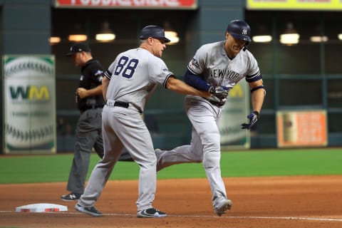 Giancarlo Stanton is congratulated by his third base coach Phil Nevin after his solo home run against the Houston Astros during the sixth inning in game one of the American League Championship Series. (Photo by Mike Ehrmann/Getty Images)