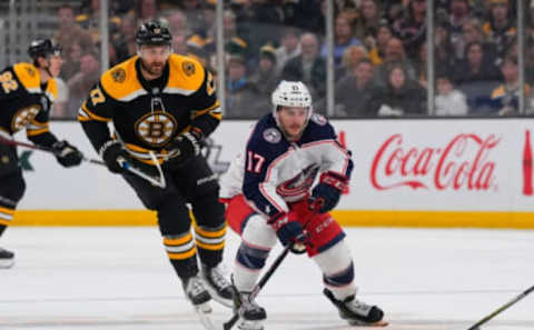 Apr 2, 2022; Boston, Massachusetts, USA; Columbus Blue Jackets right wing Justin Danforth (17) skates with the puck against Boston Bruins left wing Nick Foligno (17) during the second period at TD Garden. Mandatory Credit: Gregory Fisher-USA TODAY Sports