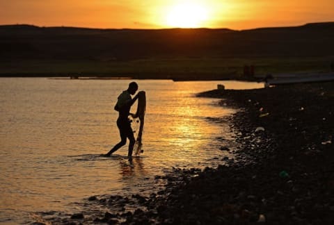 A fisherman from the El Molo tribe walks along Lake Turkana.