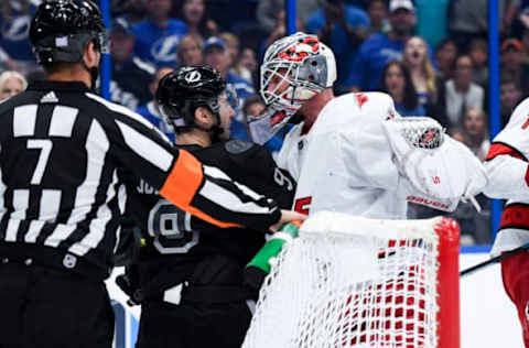 Nov 30, 2019; Tampa, FL, USA; Tampa Bay Lightning center Tyler Johnson (9) has a shoving match with Carolina Hurricanes goaltender James Reimer (47) during the third period at Amalie Arena. Mandatory Credit: Douglas DeFelice-USA TODAY Sports