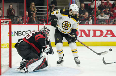 RALEIGH, NC – MAY 14: Boston Bruins left wing Jake DeBrusk (74) watches a puck shot by Boston Bruins left wing Brad Marchand (63) slide by Carolina Hurricanes goaltender Curtis McElhinney (35) during a game between the Boston Bruins and the Carolina Hurricanes on May 14, 2019 at the PNC Arena in Raleigh, NC. (Photo by Greg Thompson/Icon Sportswire via Getty Images)