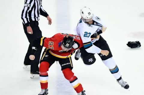 CALGARY, AB – DECEMBER 31: Sam Bennett #93 of the Calgary Flames and Barclay Goodrow #23 of the San Jose Sharks fight during an NHL game on December 31, 2018 at the Scotiabank Saddledome in Calgary, Alberta, Canada. (Photo by Brett Holmes/NHLI via Getty Images)