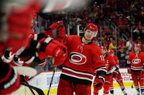 RALEIGH, NC – DECEMBER 28: Warren Foegele #13 of the Carolina Hurricanes scores a goal and skates back to the bench to celebrate with teammates during an NHL game against the Washington Capitals on December 28, 2019, at PNC Arena in Raleigh, North Carolina. (Photo by Gregg Forwerck/NHLI via Getty Images)