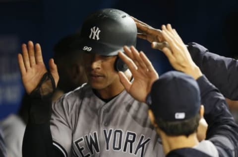 Jun 2, 2017; Toronto, Ontario, CAN; New York Yankees right fielder Aaron Judge (99) is congratulated after scoring in the seventh inning against the Toronto Blue Jays at Rogers Centre. Mandatory Credit: John E. Sokolowski-USA TODAY Sports