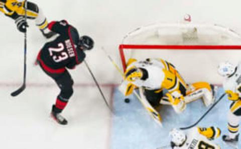 Jan 14, 2023; Raleigh, North Carolina, USA; Pittsburgh Penguins goaltender Casey DeSmith (1) stops the shot by Carolina Hurricanes right wing Stefan Noesen (23) during the second period at PNC Arena. Mandatory Credit: James Guillory-USA TODAY Sports