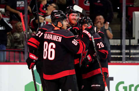 RALEIGH, NC – OCTOBER 11: Dougie Hamilton #19 of the Carolina Hurricanes celebrates with teammates after scoring a goal during an NHL game against the New York Islanders on October 11, 2019 at PNC Arena in Raleigh North Carolina. (Photo by Gregg Forwerck/NHLI via Getty Images)