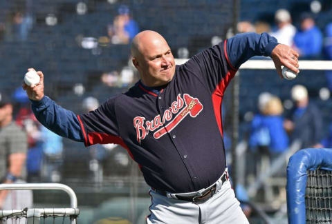 May 14, 2016; Kansas City, MO, USA; Atlanta Braves manager Fredi Gonzalez (33) delivers a pitch during batting practice prior to a game against the Kansas City Royals at Kauffman Stadium. Mandatory Credit: Peter G. Aiken-USA TODAY Sports