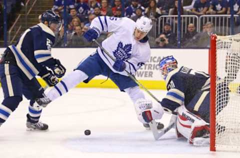 Feb 15, 2017; Columbus, OH, USA; Columbus Blue Jackets defenseman Ryan Murray (27) defends against Toronto Maple Leafs left wing Matt Martin (15) in front of Columbus Blue Jackets goalie Joonas Korpisalo (70) in the first period at Nationwide Arena. Mandatory Credit: Aaron Doster-USA TODAY Sports