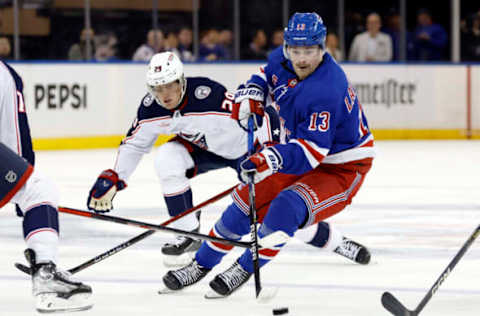 NEW YORK, NEW YORK – NOVEMBER 12: Alexis Lafreniere #13 of the New York Rangers controls the puck as Patrik Laine #29 of the Columbus Blue Jackets defends during the second period at Madison Square Garden on November 12, 2023 in New York City. (Photo by Sarah Stier/Getty Images)