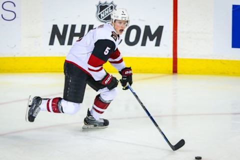 Jan 7, 2016; Calgary, Alberta, CAN; Arizona Coyotes defenseman Connor Murphy (5) controls the puck against the Calgary Flames during the third period at Scotiabank Saddledome. Arizona Coyotes won 2-1. Mandatory Credit: Sergei Belski-USA TODAY Sports