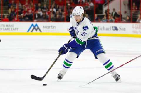 Dec 13, 2016; Raleigh, NC, USA; Vancouver Canucks defensemen Ben Hutton (27) skates with the puck against the Carolina Hurricanes at PNC Arena. The Carolina Hurricanes defeated the Vancouver Canucks 8-6. Mandatory Credit: James Guillory-USA TODAY Sports