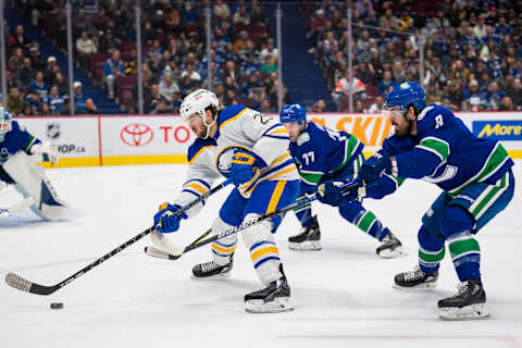 Mar 20, 2022; Vancouver, British Columbia, CAN; Vancouver Canucks forward Conor Garland (8) stick checks Buffalo Sabres forward Vinnie Hinostroza (29) in the second period at Rogers Arena. Mandatory Credit: Bob Frid-USA TODAY Sports