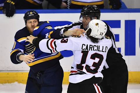 Feb 8, 2015; St. Louis, MO, USA; St. Louis Blues center Steve Ott (9) and Chicago Blackhawks left wing Daniel Carcillo (13) fight during the third period at Scottrade Center. The Blackhawks won 4-2. Mandatory Credit: Jasen Vinlove-USA TODAY Sports